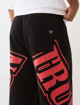 TRUE RELIGION OVERT ARCH LOGO BAGGY JOGGER (JET BLACK/RED)