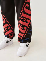 TRUE RELIGION OVERT ARCH LOGO BAGGY JOGGER (JET BLACK/RED)